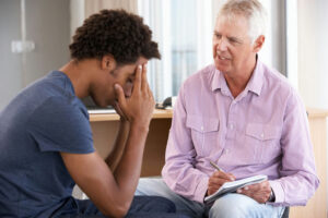therapist guiding a man through oxycodone addiction treatment