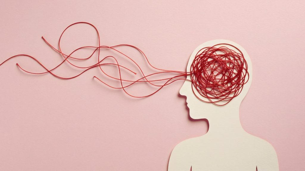 A silhouette with tangled red string representing the mental health effects of marijuana addiction