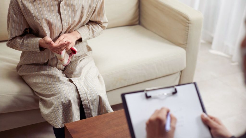 Person discussing marijuana withdrawal symptoms with a counselor during an assessment.